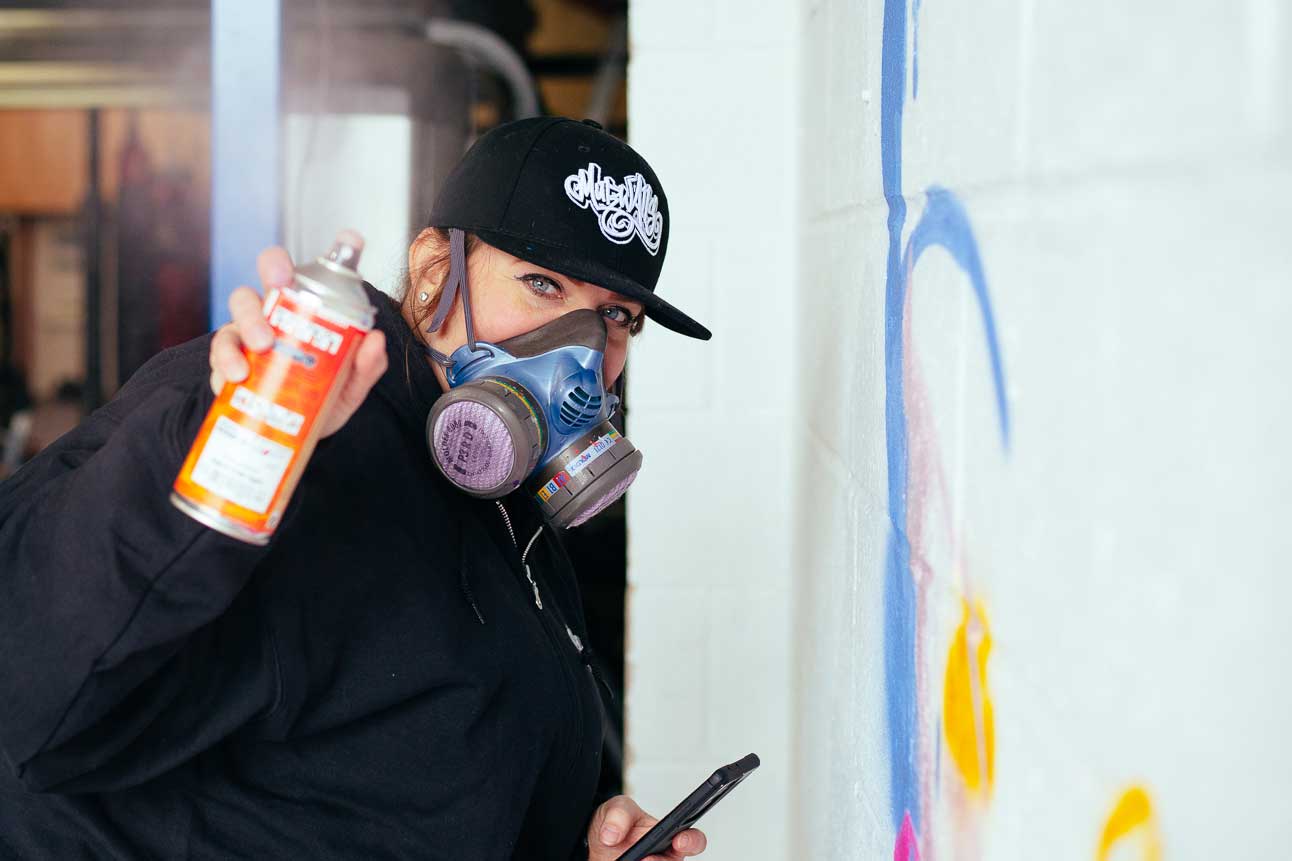 Artist beginning the Cheer Bear mural