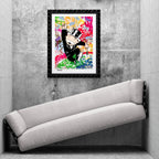 Framed Mr. Monopoly artwork displayed in a concrete interior