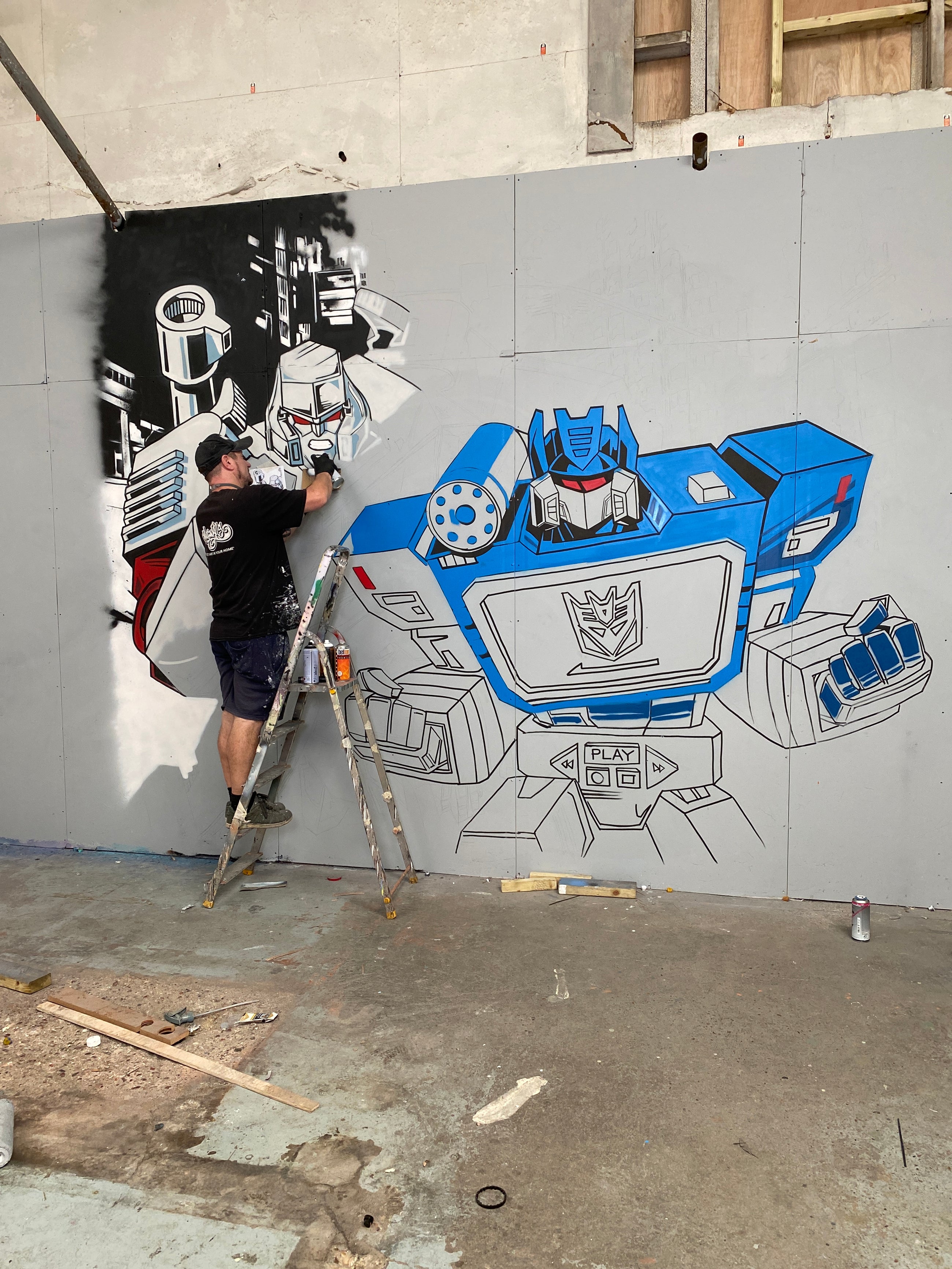 Soundwave and Megatron taking shape on the wall
