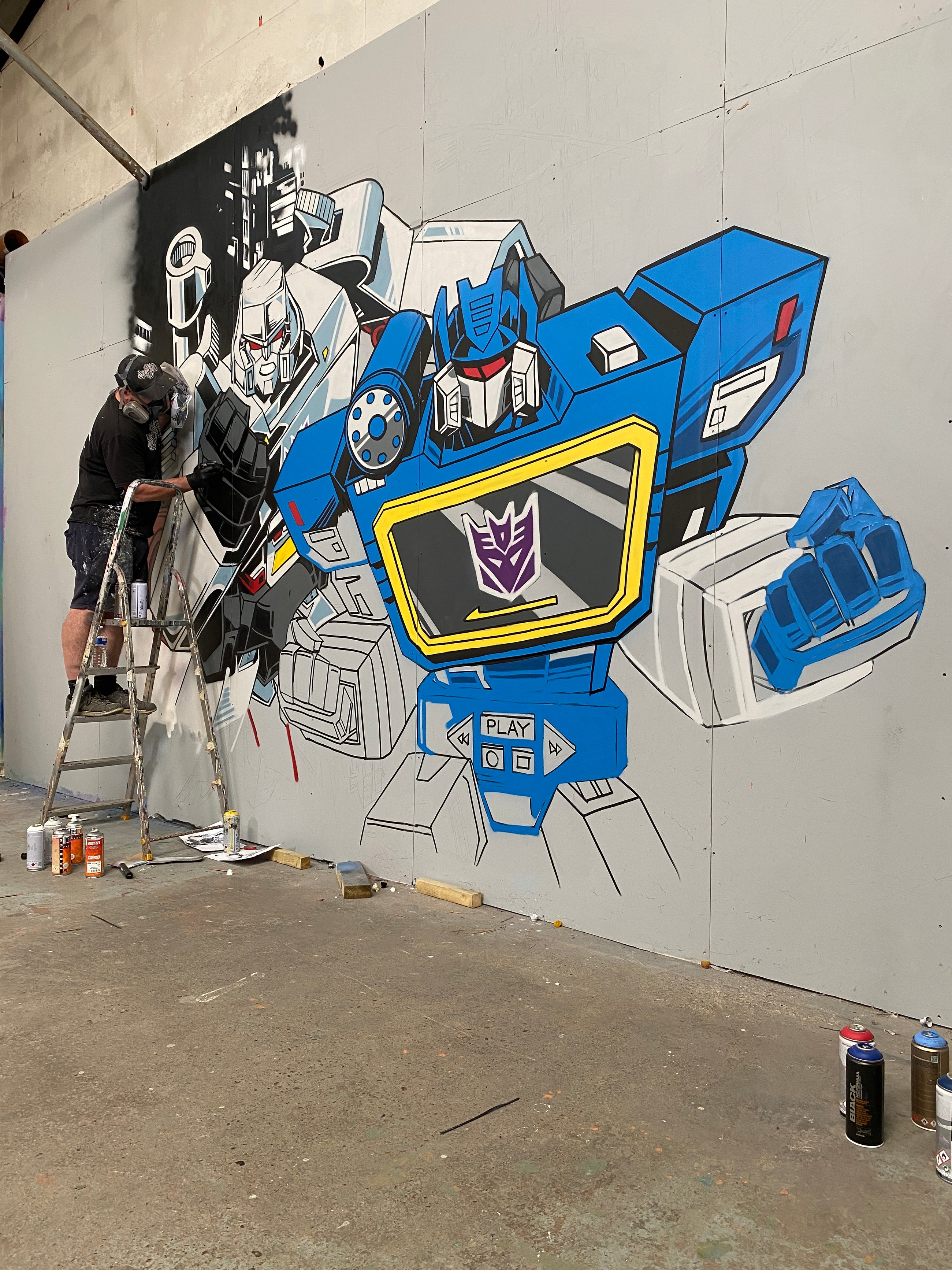 The Transformers mural during its final painting stages